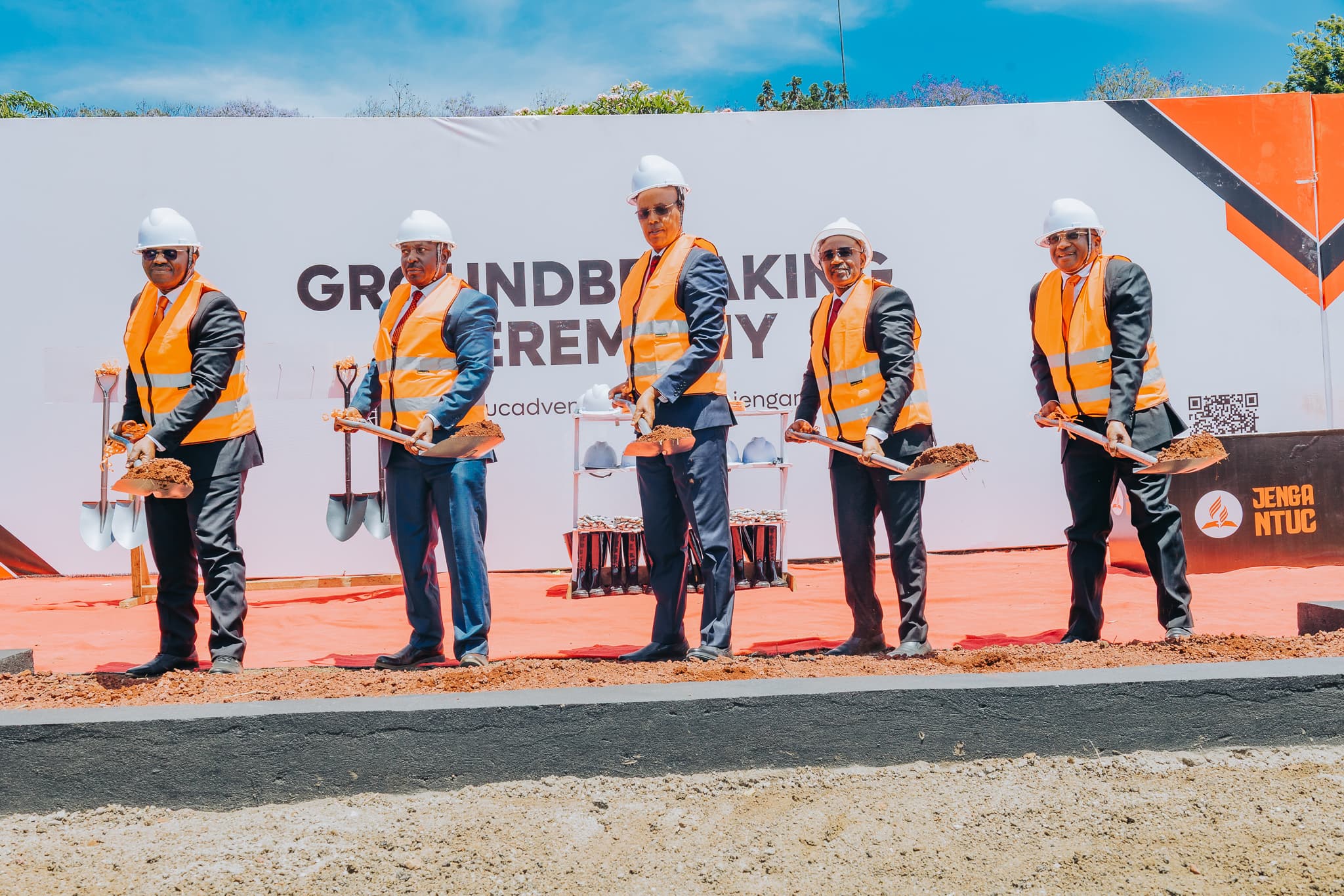 Leaders holding soil during the groundbreaking
