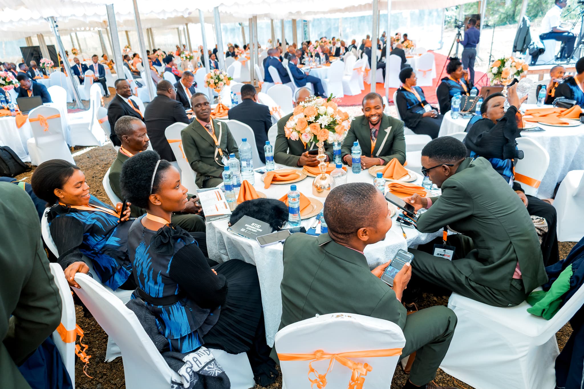 Guests seated for fellowship under the tents